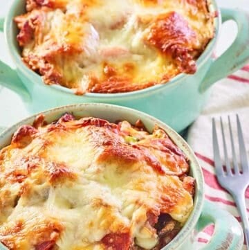 two pizza bowls with melted mozzarella cheese on top.
