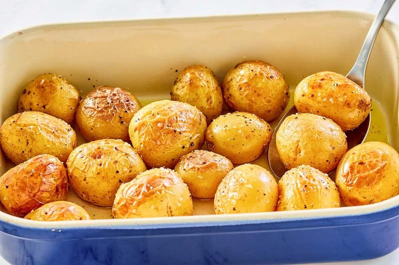 roasted baby potatoes in a blue baking dish.