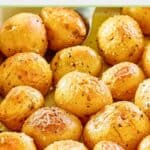 closeup of roasted baby potatoes in a blue dish.