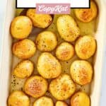 overhead view of roasted baby new potatoes in a baking dish.