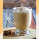 homemade Starbucks eggnog latte on a wood coaster.