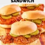 homemade wingstop buffalo chicken sandwiches on a striped wood board.