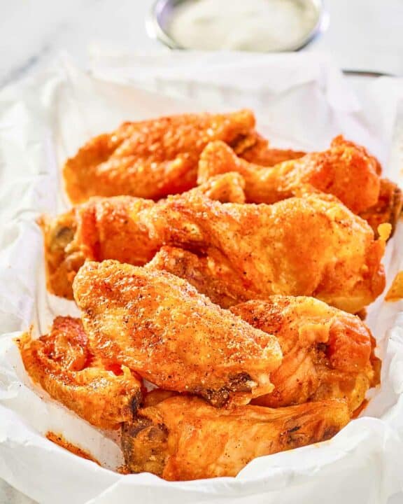 copycat Wingstop Cajun wings in a wire serving basket.