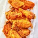 overhead view of homemade Wingstop Cajun wings in a wire basket.