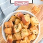 Overhead view of air fryer croutons in a white bowl.