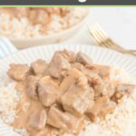 homemade beef stroganoff over rice on a white plate.