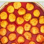 overhead view of Buffalo chicken meatballs and sauce in a large pan.
