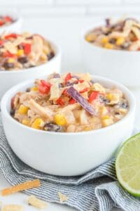 Copycat Chick Fil A chicken tortilla soup in white bowls.