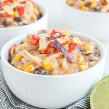 Copycat Chick Fil A chicken tortilla soup in white bowls.
