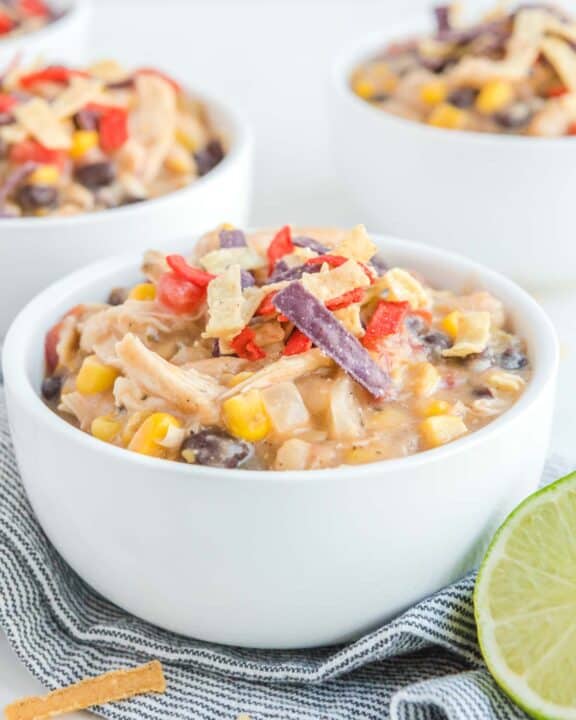 Copycat Chick Fil A chicken tortilla soup in white bowls.
