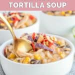 A bowl of homemade Chick Fil A chicken tortilla soup with a spoon in it.
