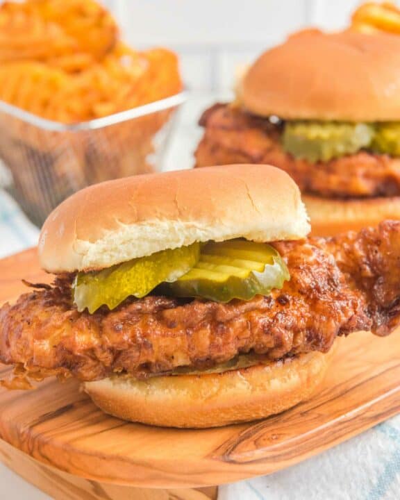Copycat Chick Fil A spicy chicken sandwich and waffle fries behind it.