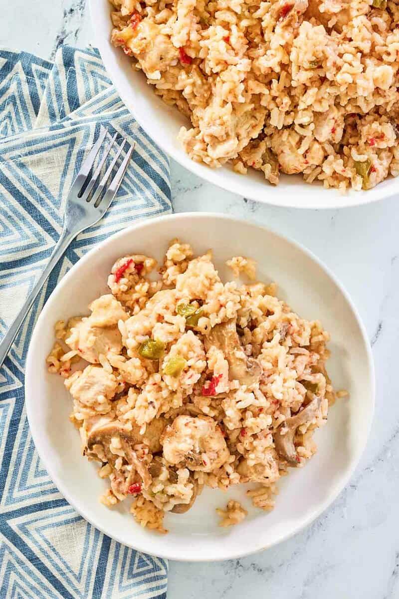 overhead view of chicken and rice casserole in a serving bowl and on a plate.