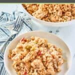 chicken and rice casserole serving on a plate and a fork on a cloth napkin.