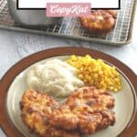 two pieces of copycat cracker barrel sunday chicken, corn, and mashed potatoes on a plate.