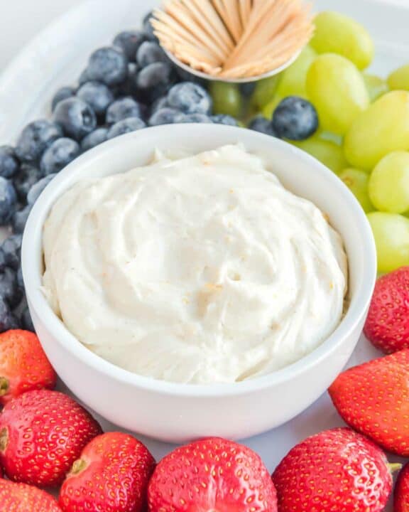 Cream cheese fruit dip, strawberries, grapes, blueberries, and toothpicks.