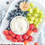 Overhead view of cream cheese fruit dip and fresh fruit on a white platter.