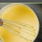 overhead view of a whisk and hollandaise sauce in a pan.