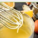 hollandaise sauce on a whisk held over a pan with the sauce.