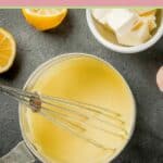 overhead view of hollandaise sauce and a whisk in a pan.