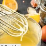 homemade hollandaise sauce in a pan and on a whisk.