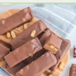 homemade snickers bars on a wood board.