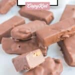 homemade snickers bars scattered on a table.