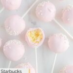 Homemade Starbucks cake pops scattered on a marble surface.