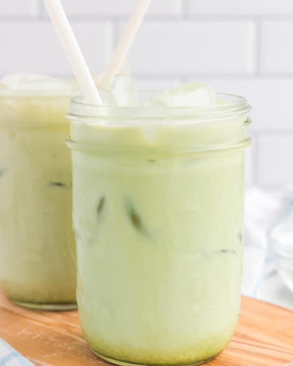 copycat Starbucks matcha latte drinks on a wood board.