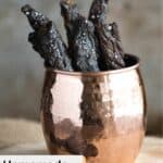 Homemade teriyaki beef jerky in a brass cup.
