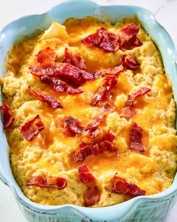 Twice baked cauliflower in a blue casserole dish.