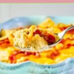 Twice baked cauliflower on a spoon in front of the dish.