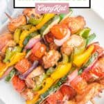 Overhead view of air fryer chicken kabobs piled on a platter.