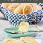 Angel biscuits topped with butter and in a basket.