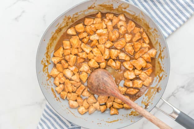 Cooked chicken pieces in an Asian sauce.