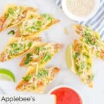 Overhead view of Applebee's chicken wonton tacos on a marble surface.