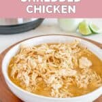 A bowl of homemade Cafe Rio shredded chicken on a wood board.