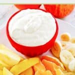 Cool whip fruit dip and fresh fruit slices beside it.