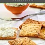 Homemade crackers and one with garlic cheese spread on it.