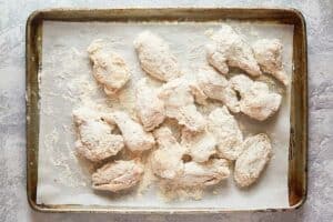 Breaded chicken wings on a tray.