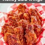 Homemade KFC honey barbecue chicken wings in a parchment lined basket.