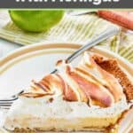 A slice of key lime meringue pie, a fork, and a lime.