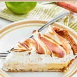 A slice of key lime pie with meringue topping.