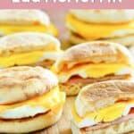 Homemade McDonald's egg mcmuffins on a wood platter.
