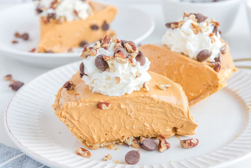 Slices of copycat O'Charley's caramel pie on plates.