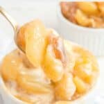 Homemade Olive Garden apple carmelina on a spoon with a bowl of it underneath.