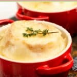 Onion soup gratinee in a red soup crock.