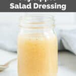 A glass jar filled with homemade Panera fuji apple salad dressing.