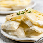 Scalloped potatoes without cheese on plates.