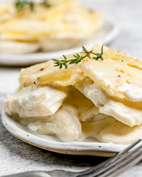 Scalloped potatoes without cheese on plates.